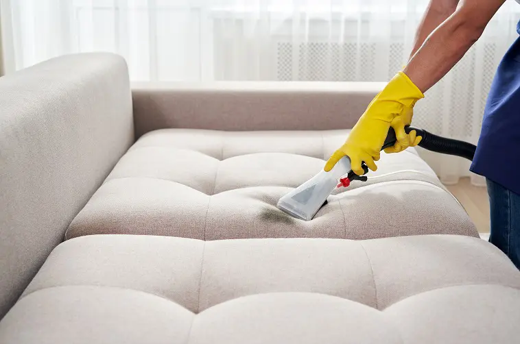 man cleaning upholstery