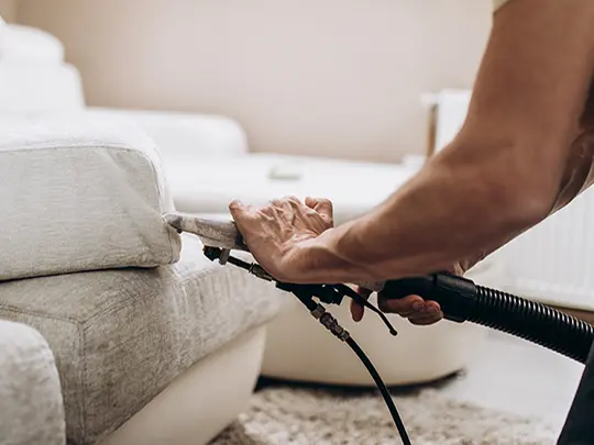 Technician cleaning couch